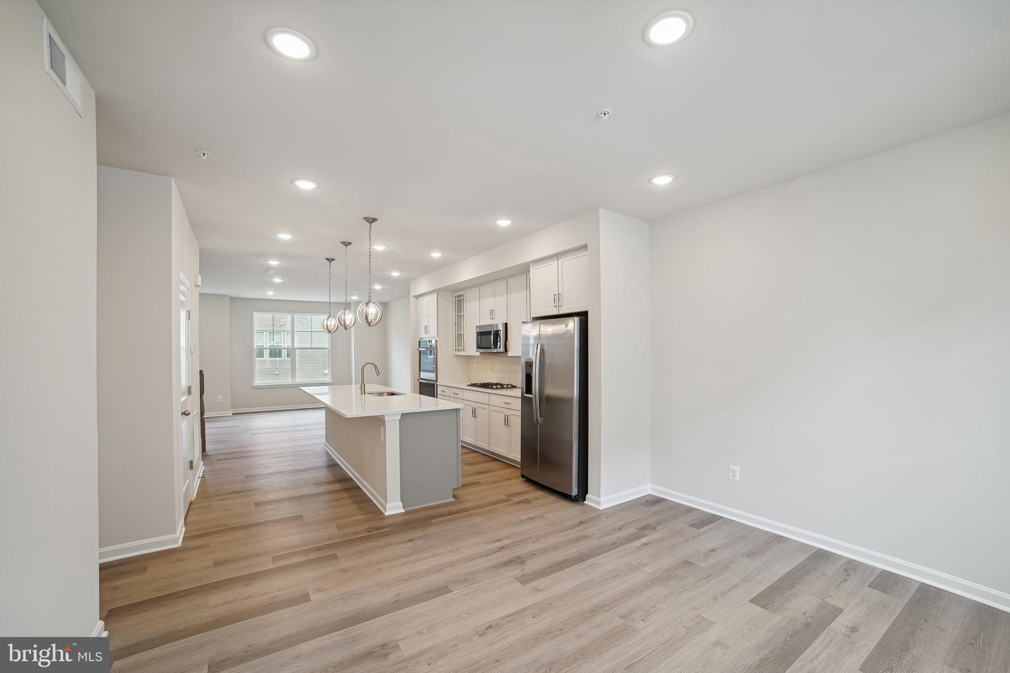2513 Gatwick Lane Frederick, MD 21701 - Photo 5 of 14 a view of a kitchen with refrigerator and microwave