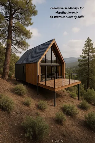 a view of a lush green field with mountains in the background