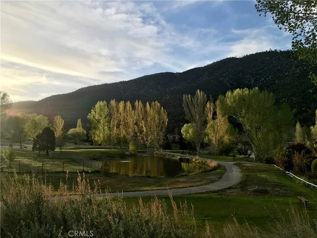 a view of a house with a yard covered in snow