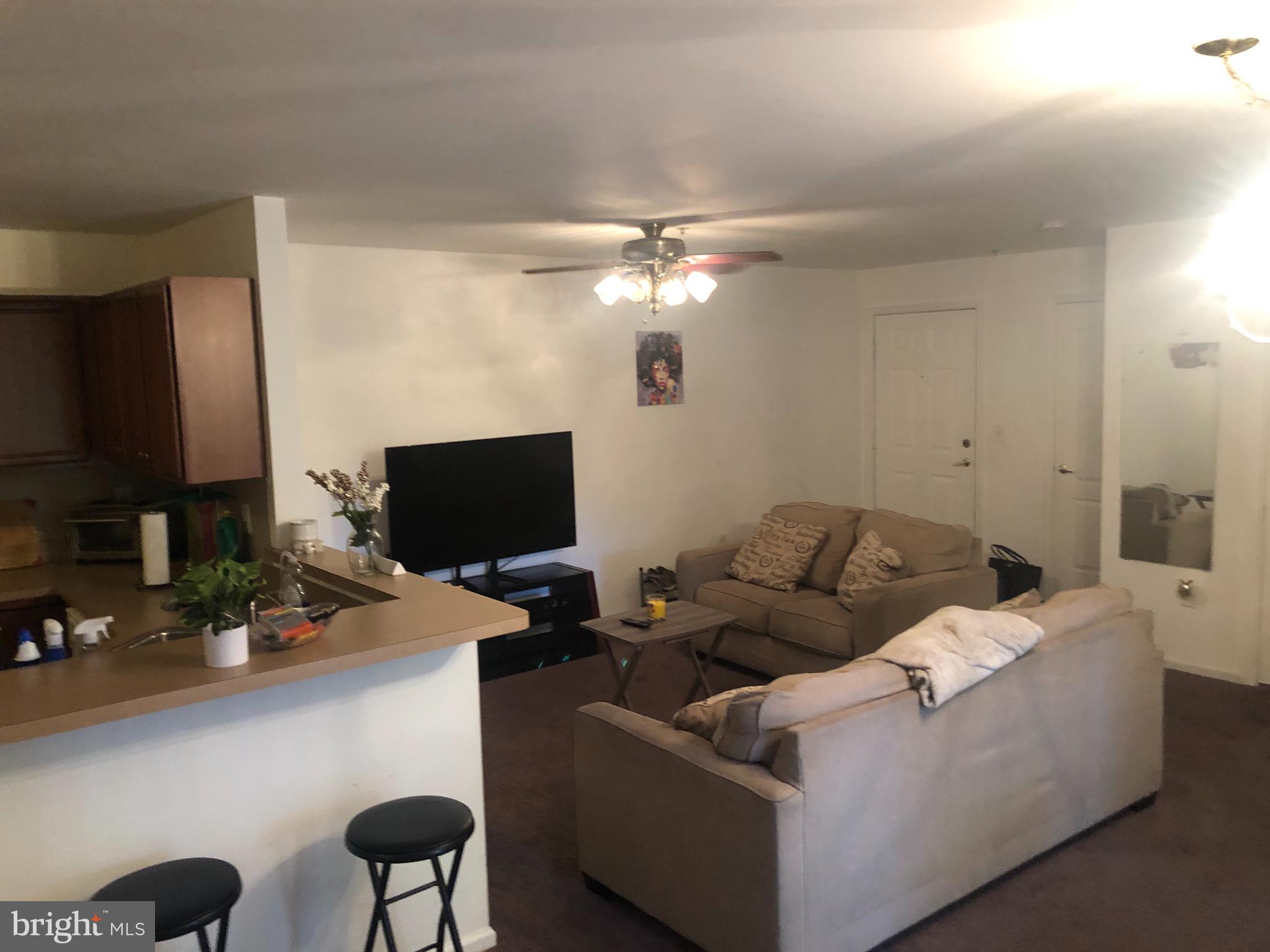 148 Natalie Road Riverside, NJ 08075 - Photo 11 of 13 a living room with furniture a flat screen tv and a fireplace
