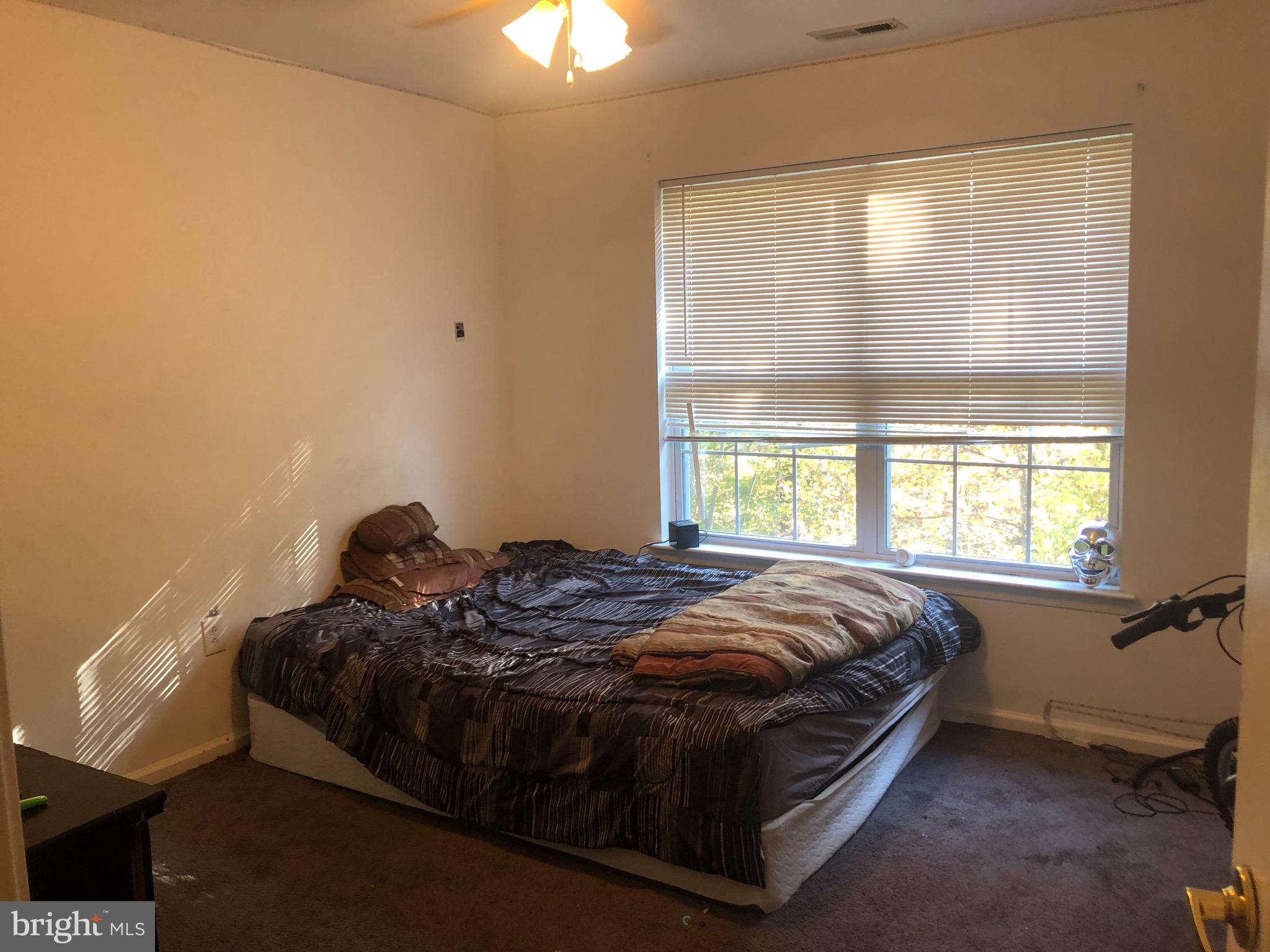 148 Natalie Road Riverside, NJ 08075 - Photo 13 of 13 a bed sitting in a bedroom next to a window