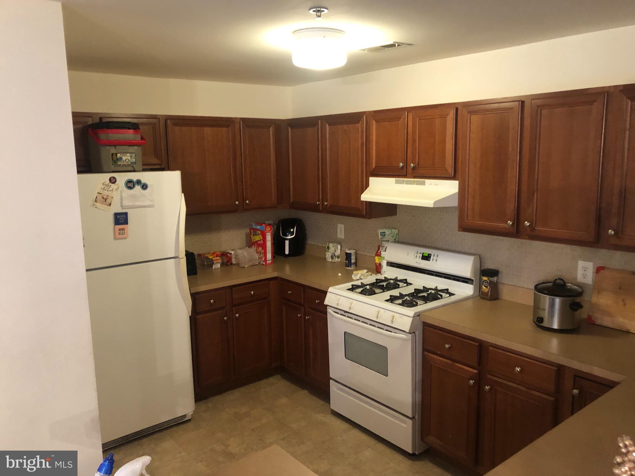 148 Natalie Road Riverside, NJ 08075 - Photo 8 of 13 a kitchen with a white stove top oven and refrigerator