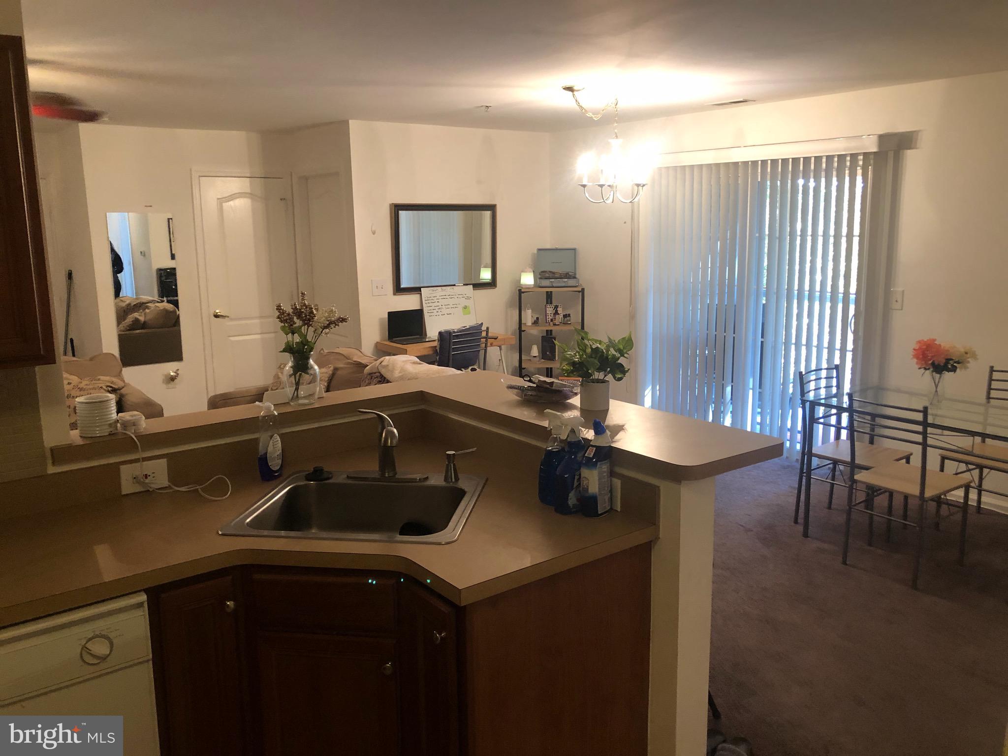 148 Natalie Road Riverside, NJ 08075 - Photo 9 of 13 a kitchen with a sink and chairs