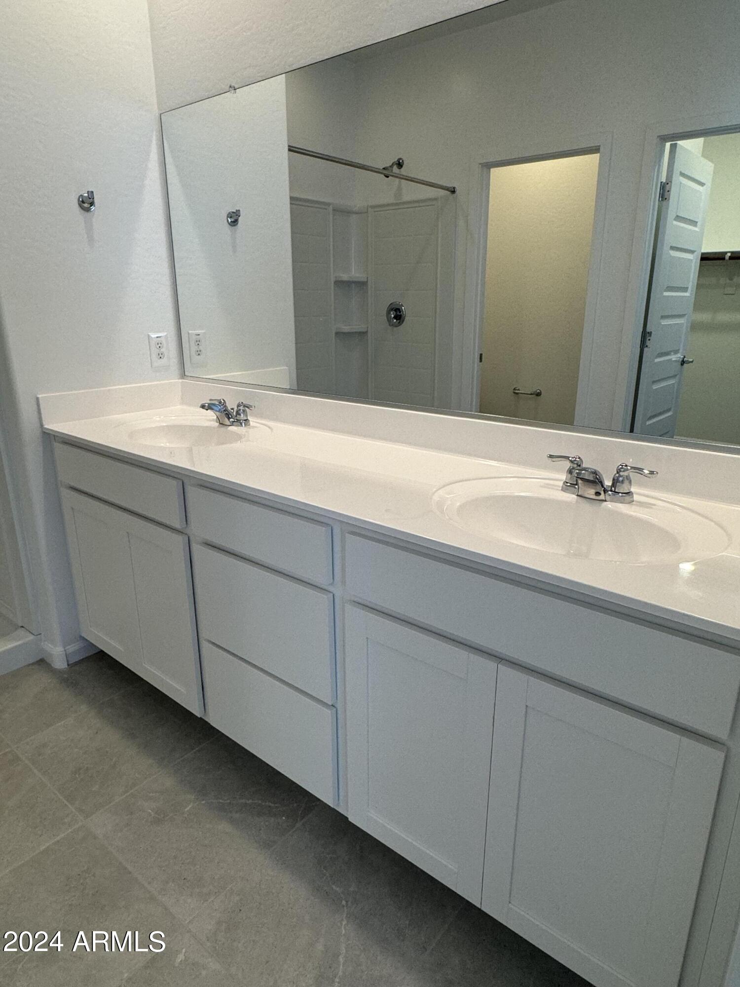 12088 East Verbina Lane Florence, AZ 85132 - Photo 18 of 48 a bathroom with a double vanity sink and mirror