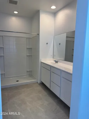 a bathroom with a shower and a sink