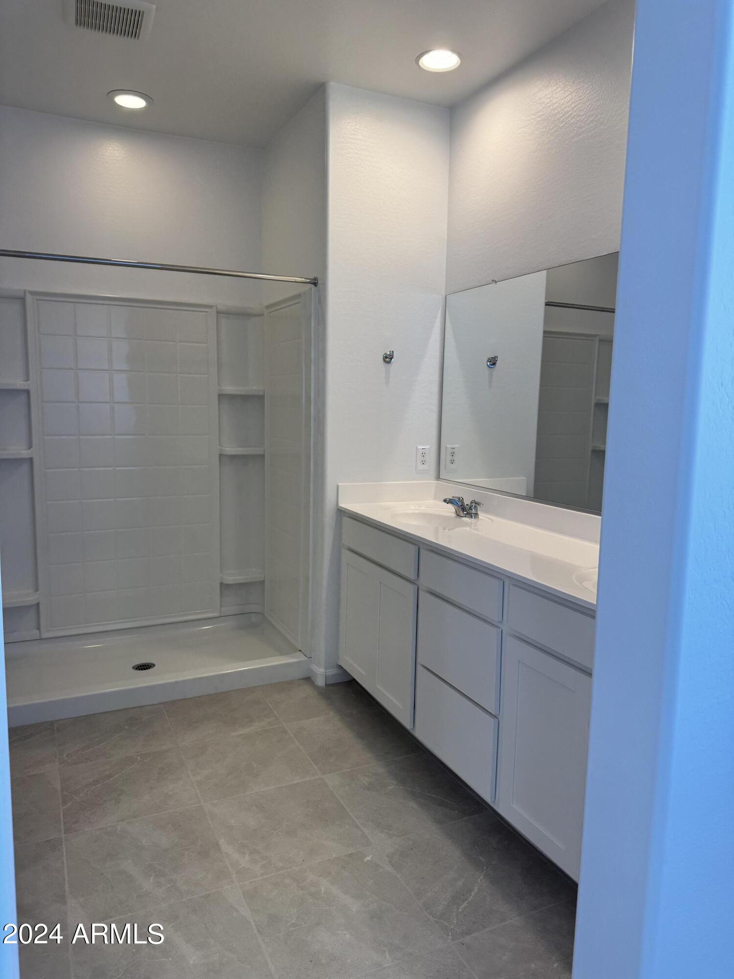 12088 East Verbina Lane Florence, AZ 85132 - Photo 20 of 48 a bathroom with a shower a sink and a mirror