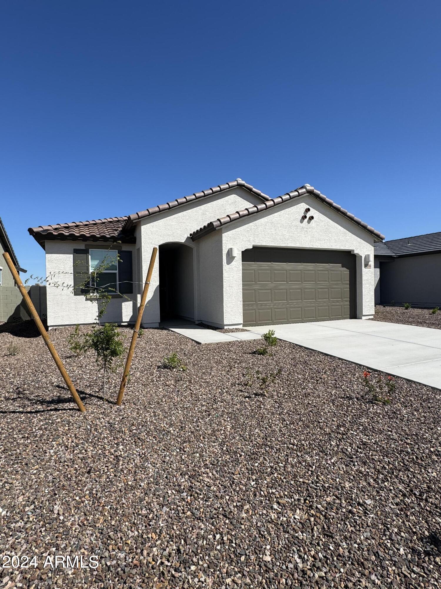 12088 East Verbina Lane Florence, AZ 85132 - Photo 2 of 48 a front view of a house with a garden