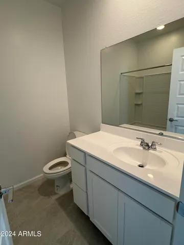 an empty room with closet and mirror