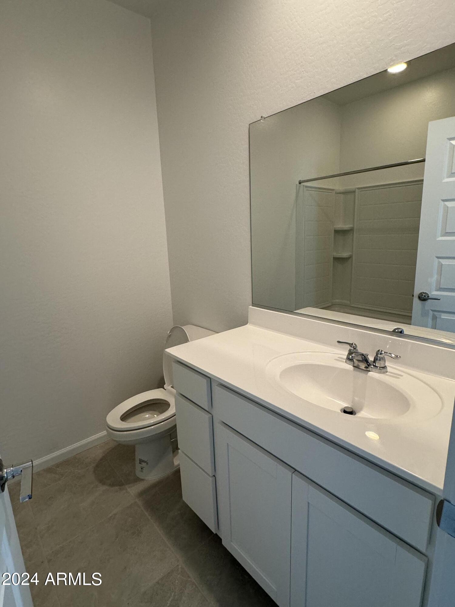 12088 East Verbina Lane Florence, AZ 85132 - Photo 27 of 48 a bathroom with a sink a toilet and mirror