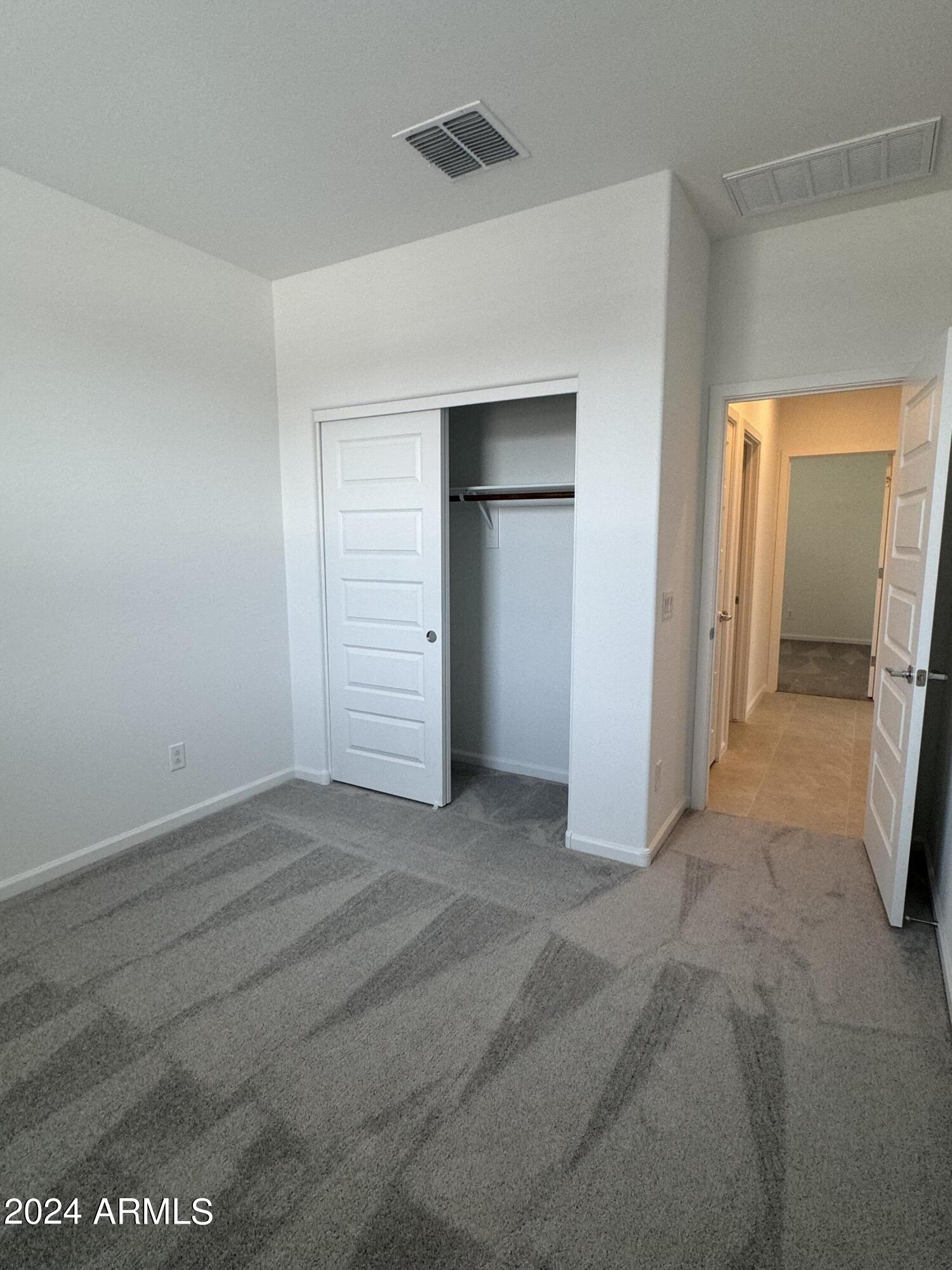 12088 East Verbina Lane Florence, AZ 85132 - Photo 30 of 48 an empty room with closet and mirror
