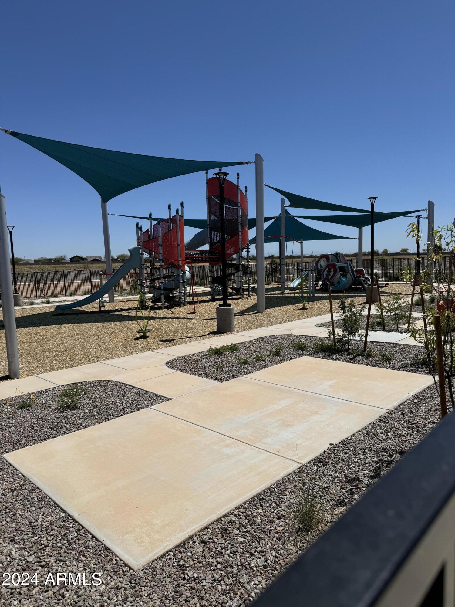 12088 East Verbina Lane Florence, AZ 85132 - Photo 36 of 48 a view of a swimming pool with a bench
