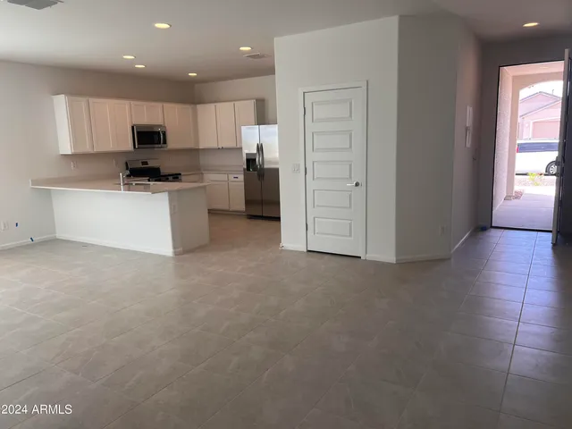 a kitchen with a refrigerator and a stove top oven