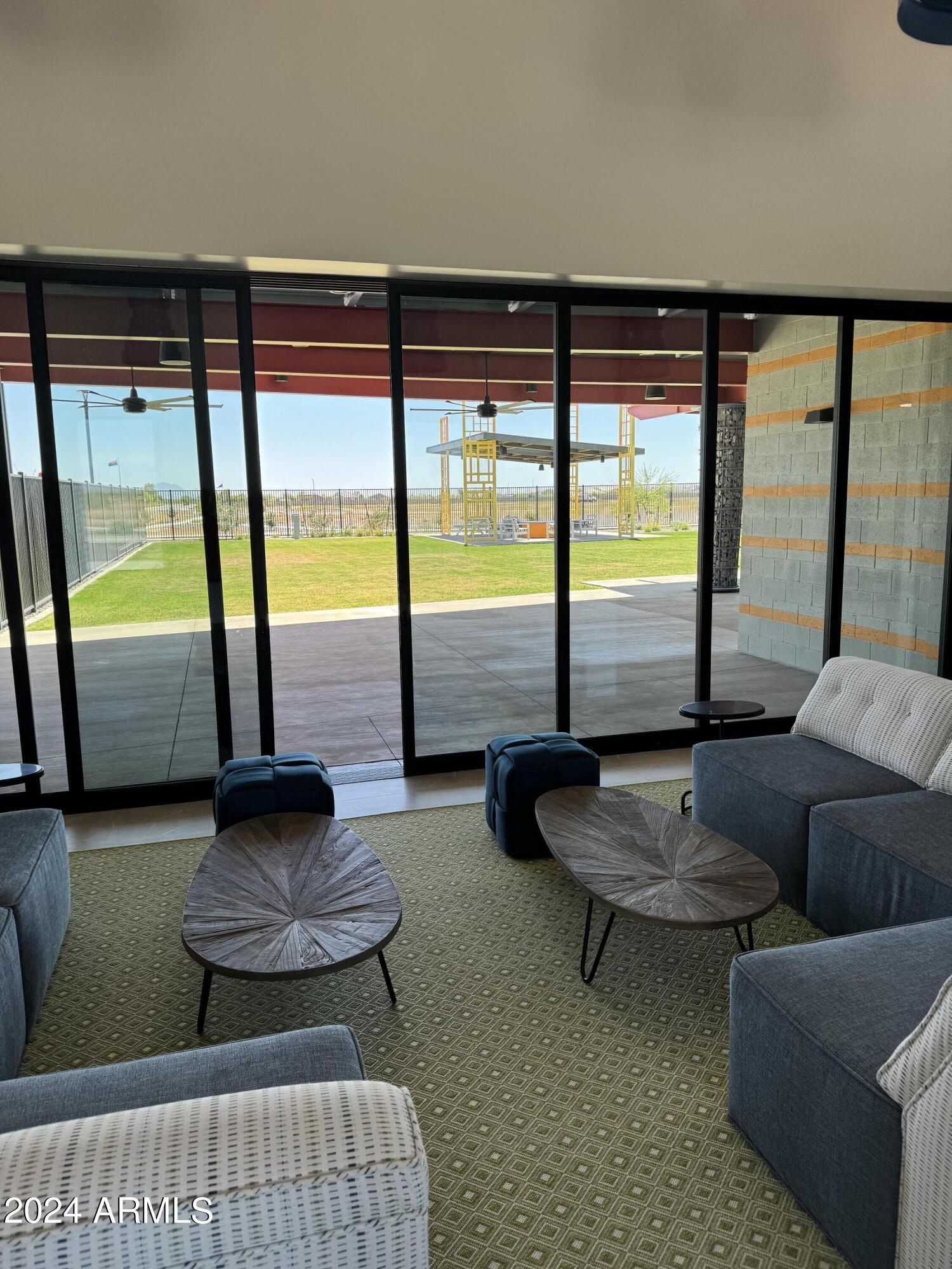 12088 East Verbina Lane Florence, AZ 85132 - Photo 46 of 48 a living room with furniture and a floor to ceiling window