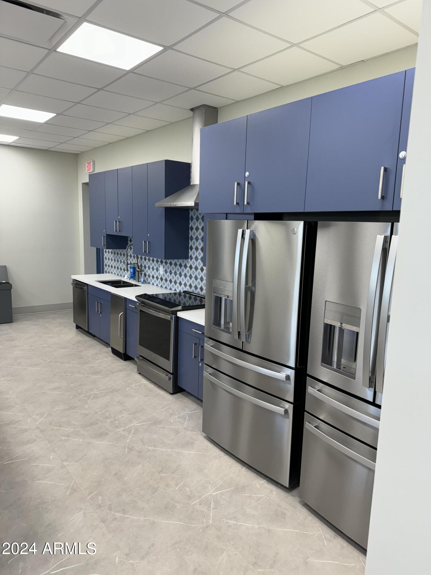 12088 East Verbina Lane Florence, AZ 85132 - Photo 47 of 48 a kitchen with stainless steel appliances a sink and a refrigerator
