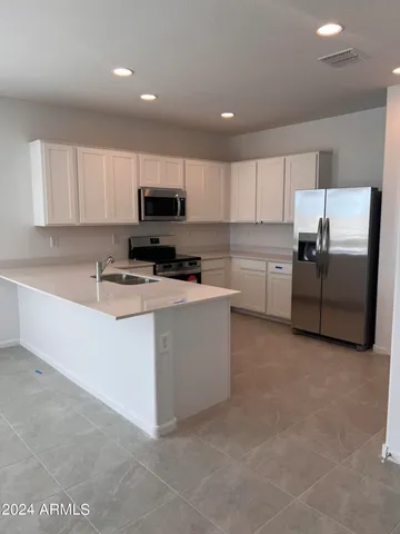 a kitchen with cabinets and stainless steel appliances