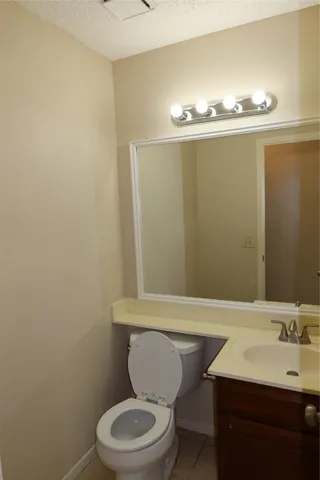 a bathroom with a sink a toilet and mirror