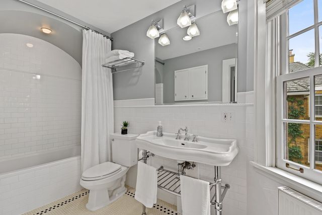 a bathroom with a sink toilet a mirror and shower