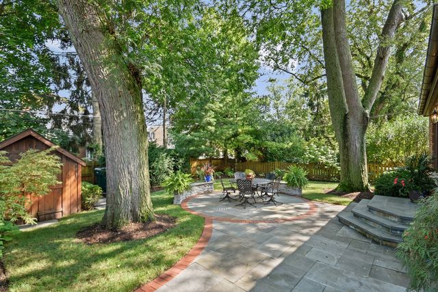 a backyard of a house with table and chairs