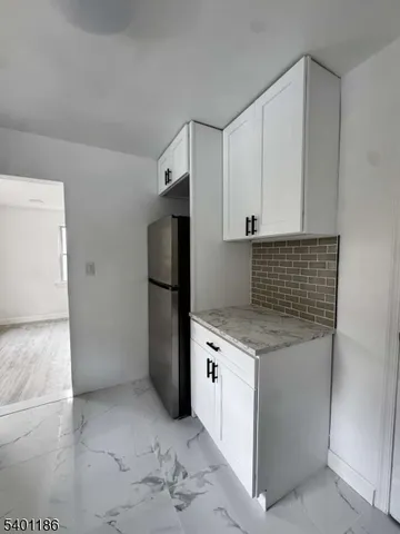 a kitchen with a stove refrigerator and microwave