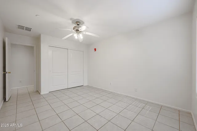 a living room with furniture and a dining table with kitchen view