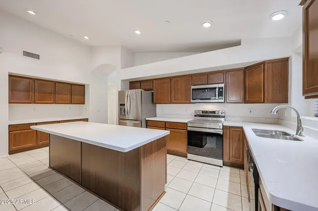 a large kitchen with stainless steel appliances lots of counter top space