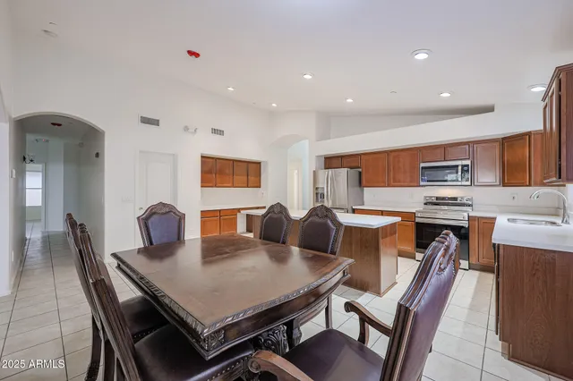 a kitchen that has a table and chairs in it
