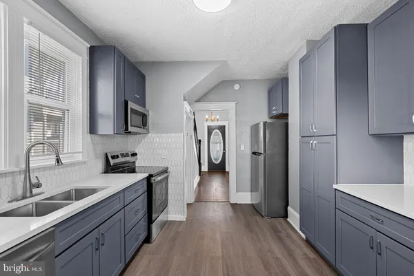 a kitchen with a sink stove and microwave