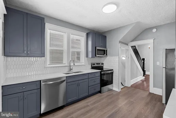 a view of walk in closet with wooden floor