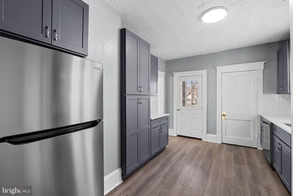 a view of a room with wooden floor and a ceiling fan