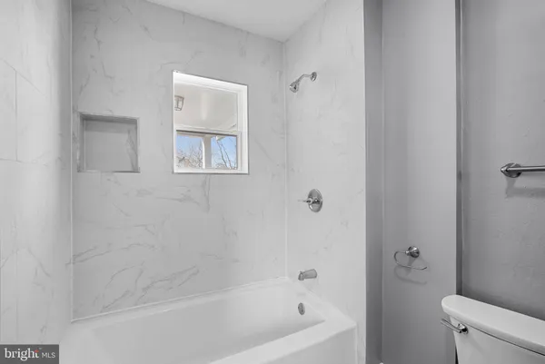 a view of a balcony with wooden floor and fence