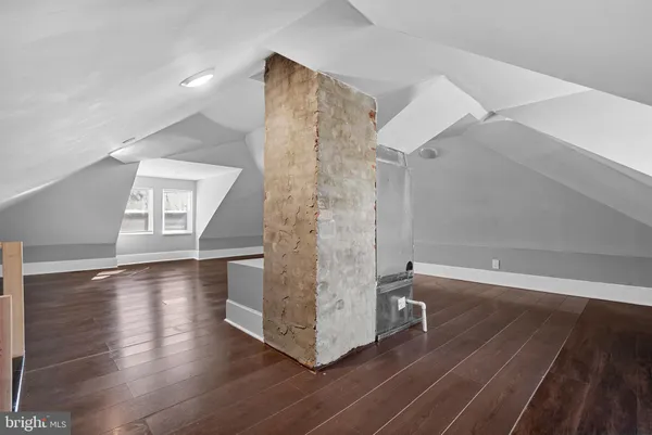 a view of a house with a yard and a large tree