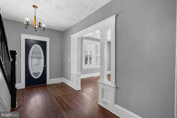 a view of a hallway with wooden floor and stairs