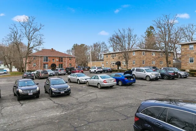 a view of cars parked in front of a house