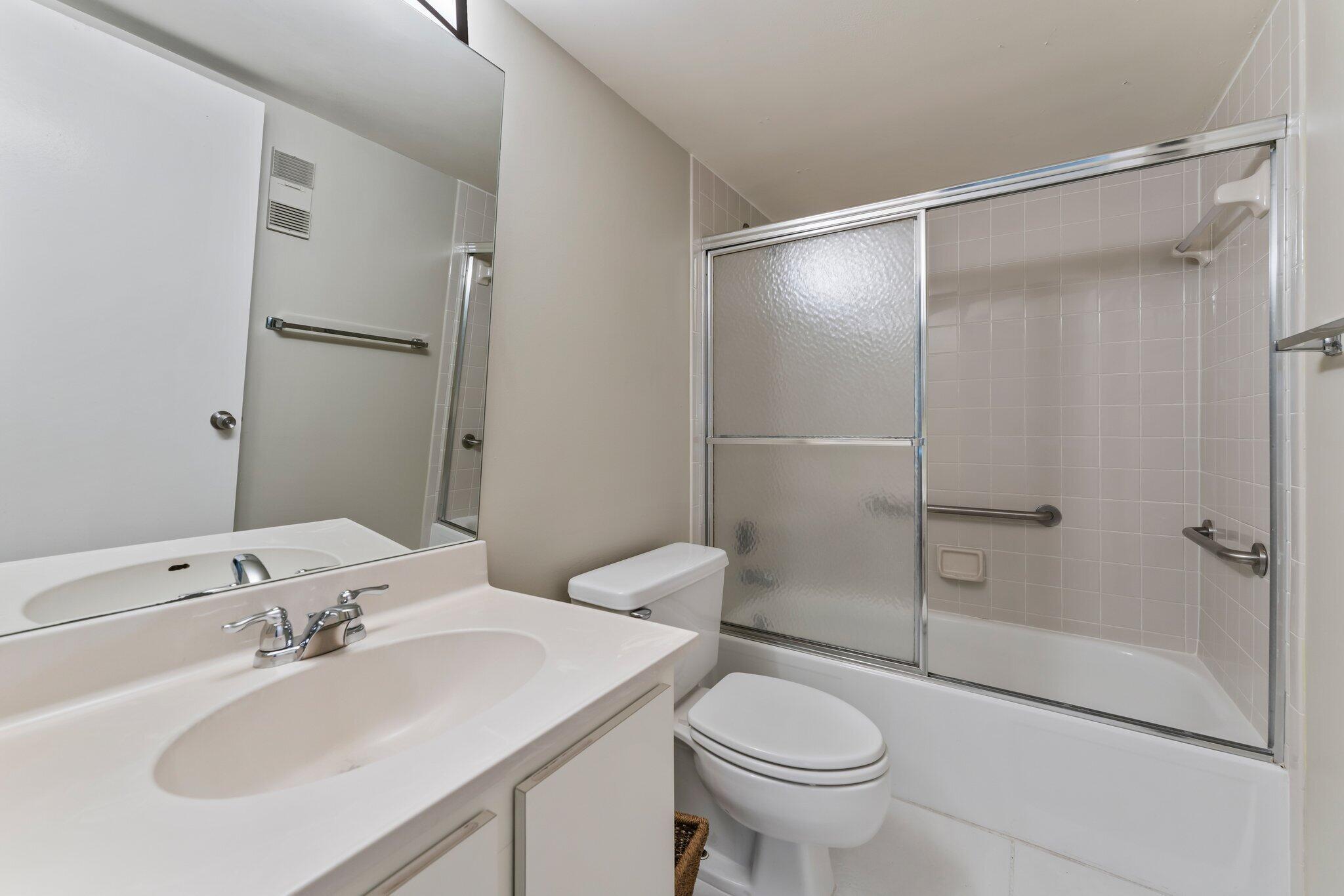 1605 Highway 1, Unit D301 Jupiter, FL 33477 - Photo 28 of 46 a bathroom with a sink toilet and shower