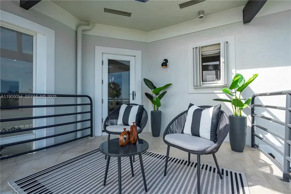a media room with lots of chairs and wooden floor
