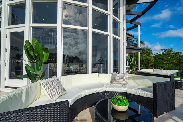 a view of a house with swimming pool and sitting area