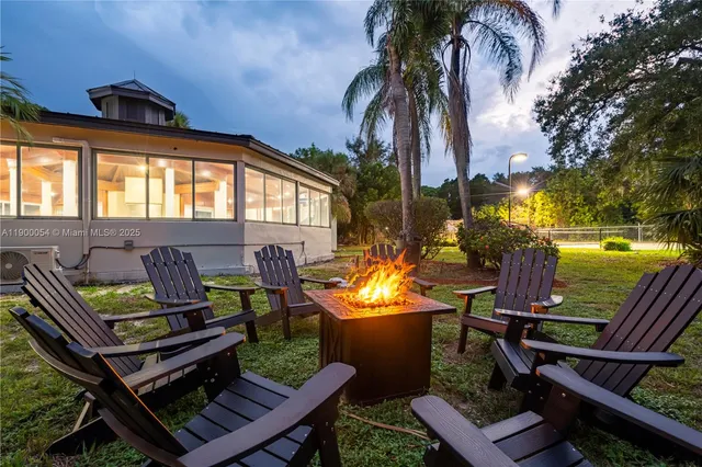 an aerial view of a house with swimming pool and outdoor space