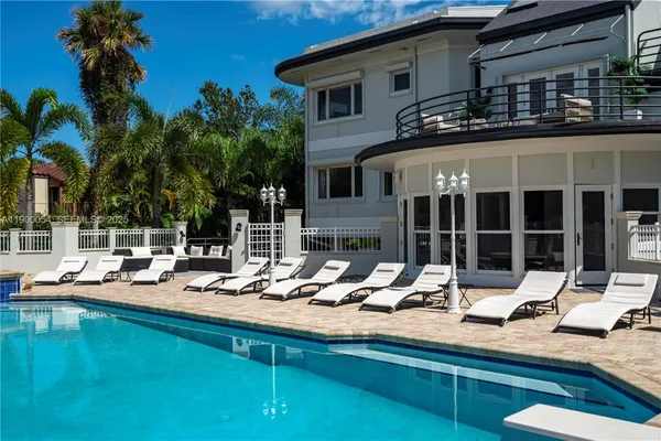 an aerial view of a house with swimming pool and outdoor space