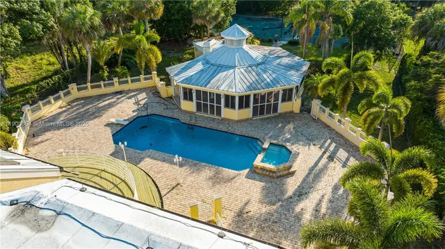 a view of a roof deck with couches and palm trees