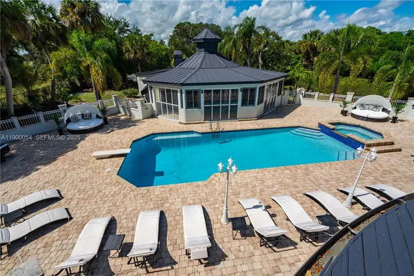 a view of a roof deck with couches and palm trees