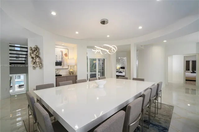 a kitchen with kitchen island granite countertop a sink a counter top space appliances and cabinets