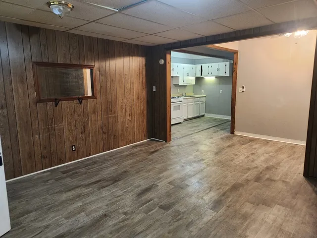 an empty room with wooden floor and a window