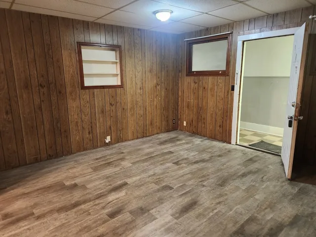 an empty room with windows and closet