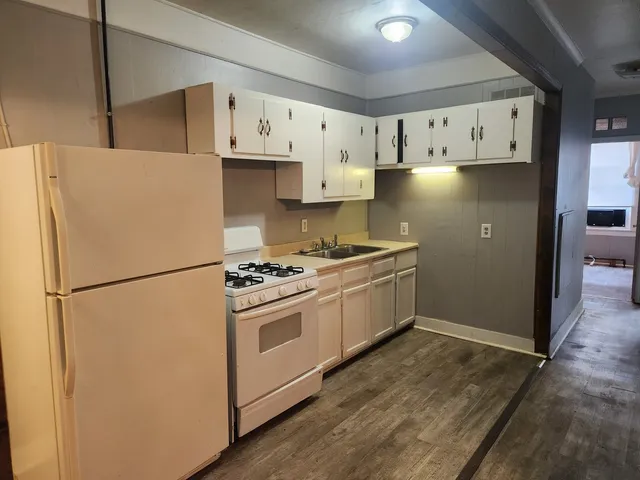 a white refrigerator freezer sitting inside of a kitchen
