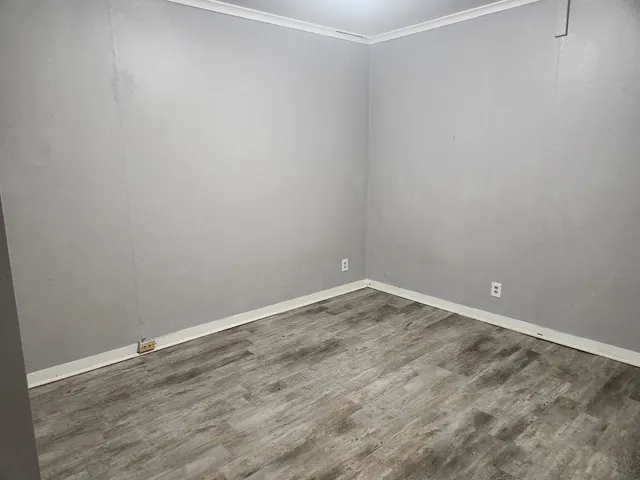 a room with an empty space and wooden floor