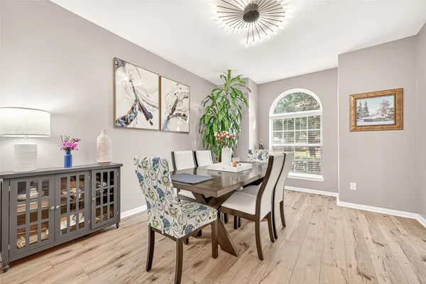 a view of a dining room with furniture and wooden floor