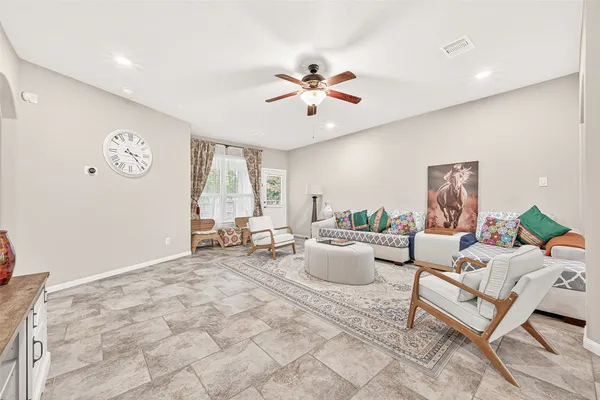 a living room with furniture and kitchen view