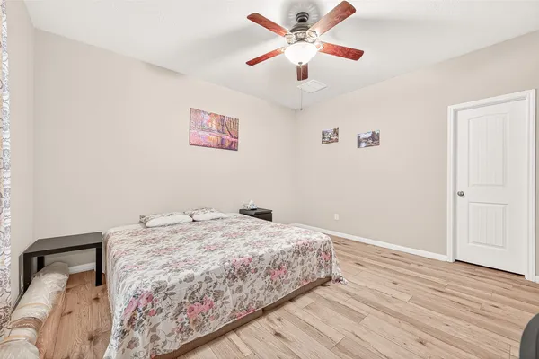 a spacious bedroom with a bed and window