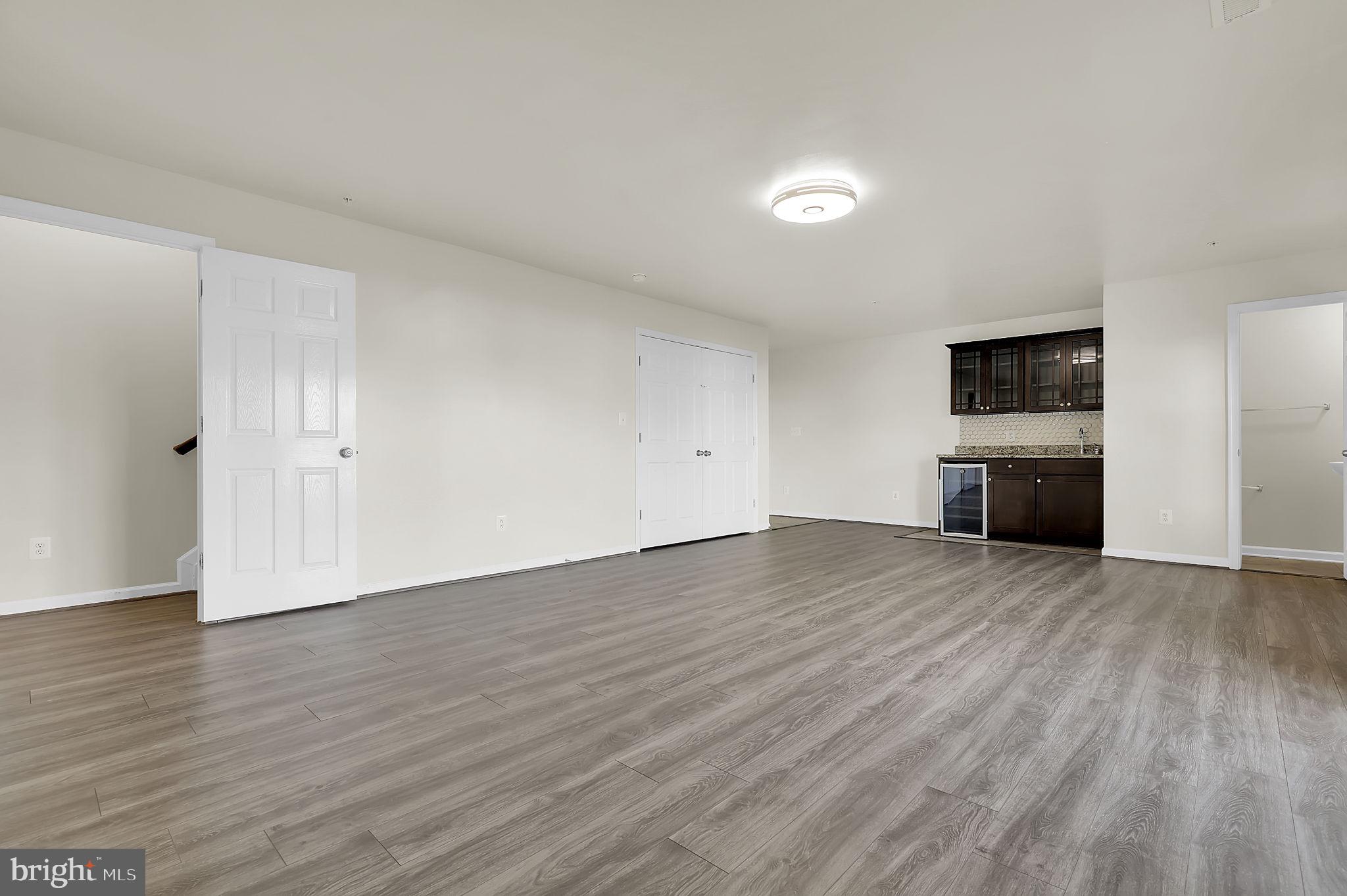 5906 Krantz Drive Frederick, MD 21703 - Photo 28 of 40 a view of empty room with wooden floor and fireplace