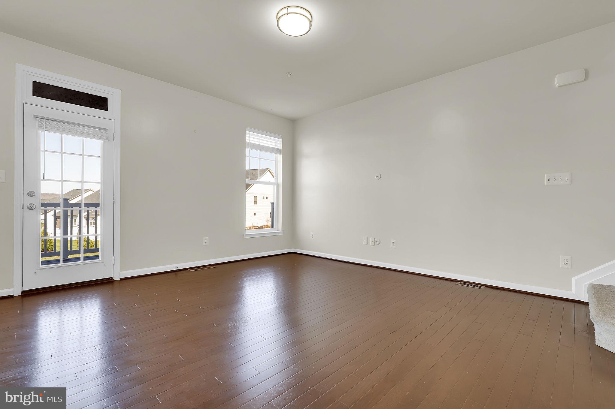 5906 Krantz Drive Frederick, MD 21703 - Photo 7 of 40 a view of a livingroom with wooden floor and a window